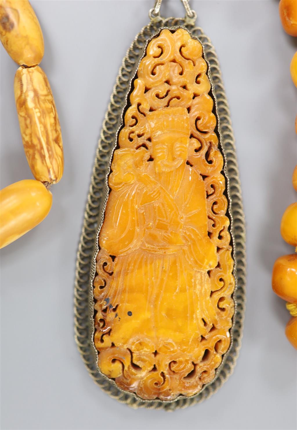Two Chinese single strand amber necklaces.